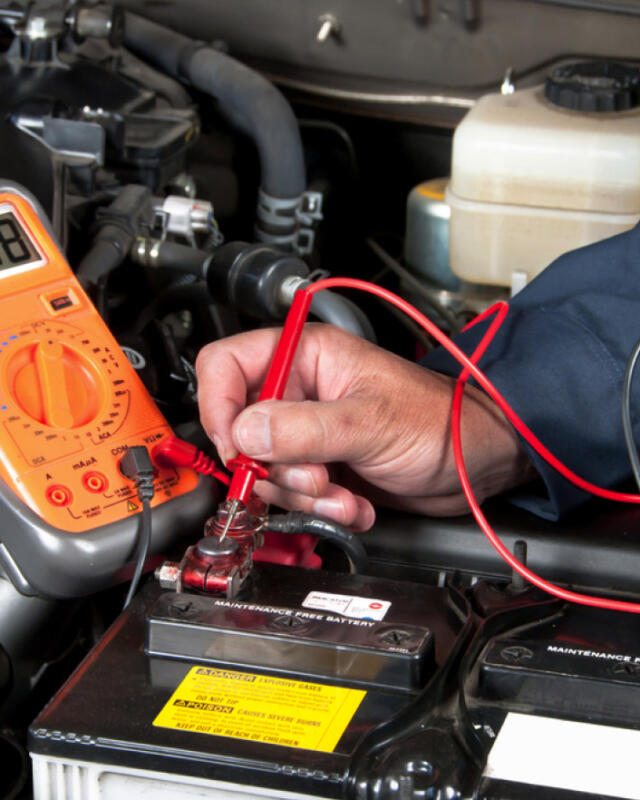 Geelong auto electrician working on machinery engine